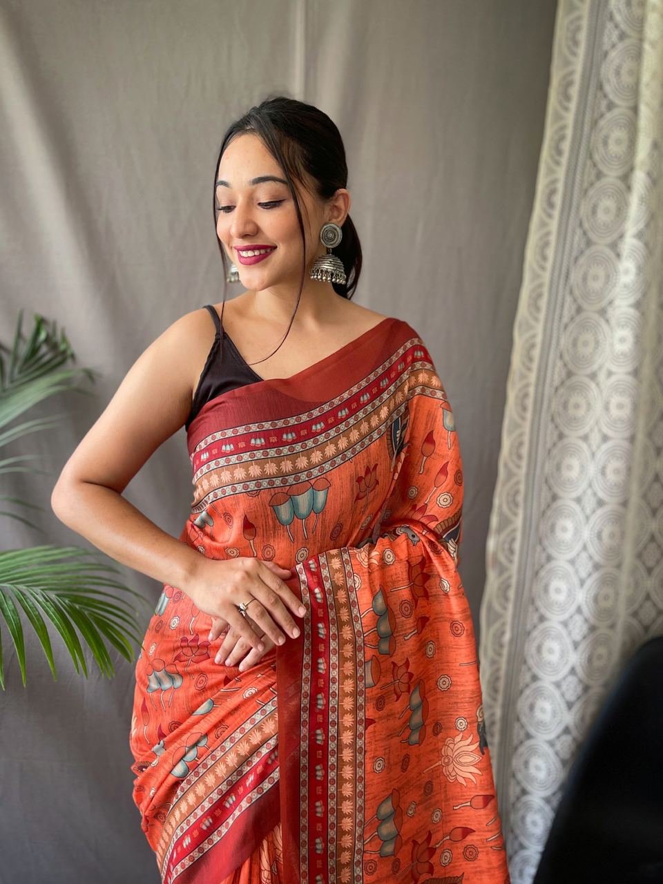 Women's Artistic Terracotta Orange Linen Saree with Kalamkari Inspired Print & Tassel Detailing – Perfect for Casual Festivities & Cultural Events